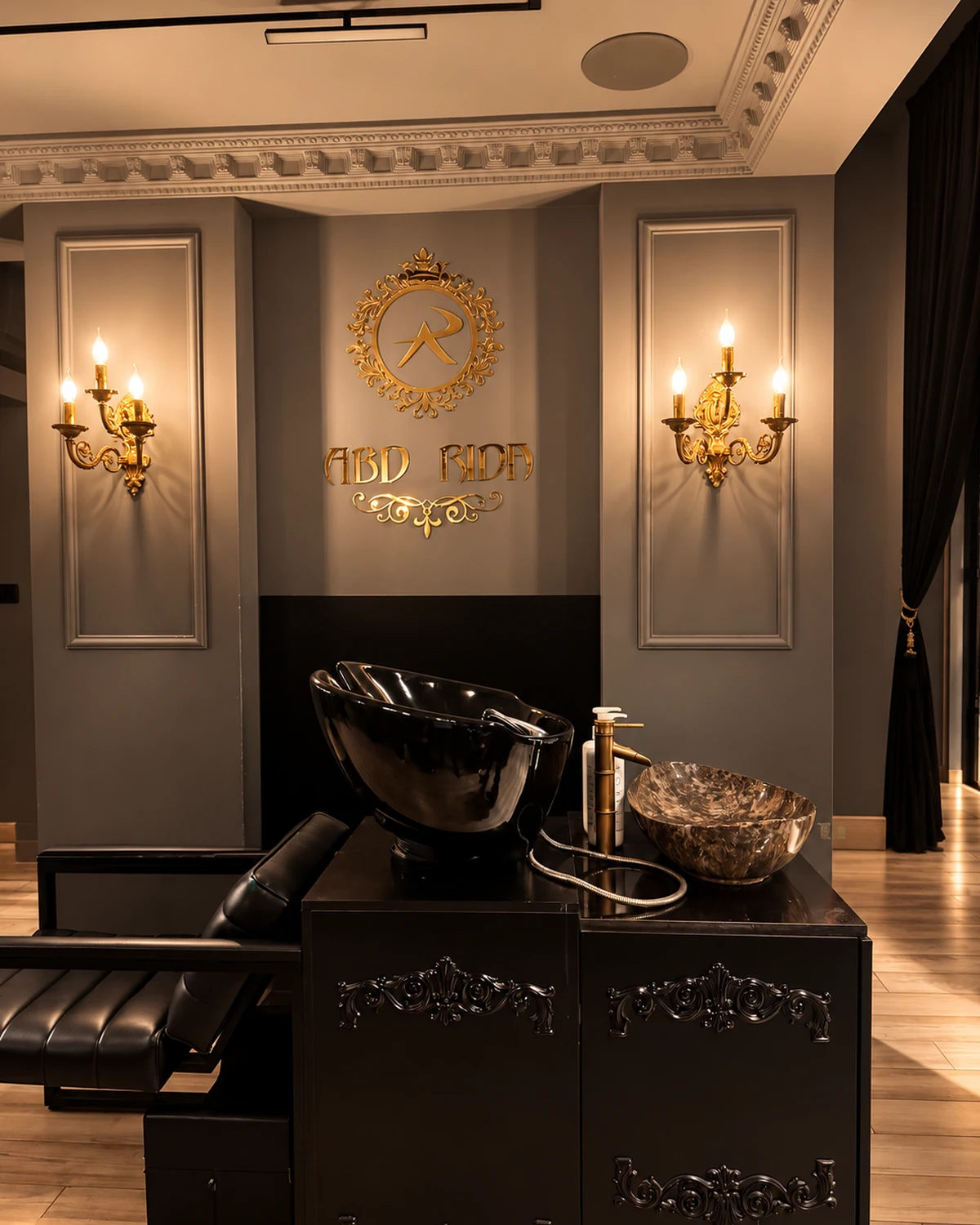 Hair wash station under the AR Barber Lab crest and wall sconces