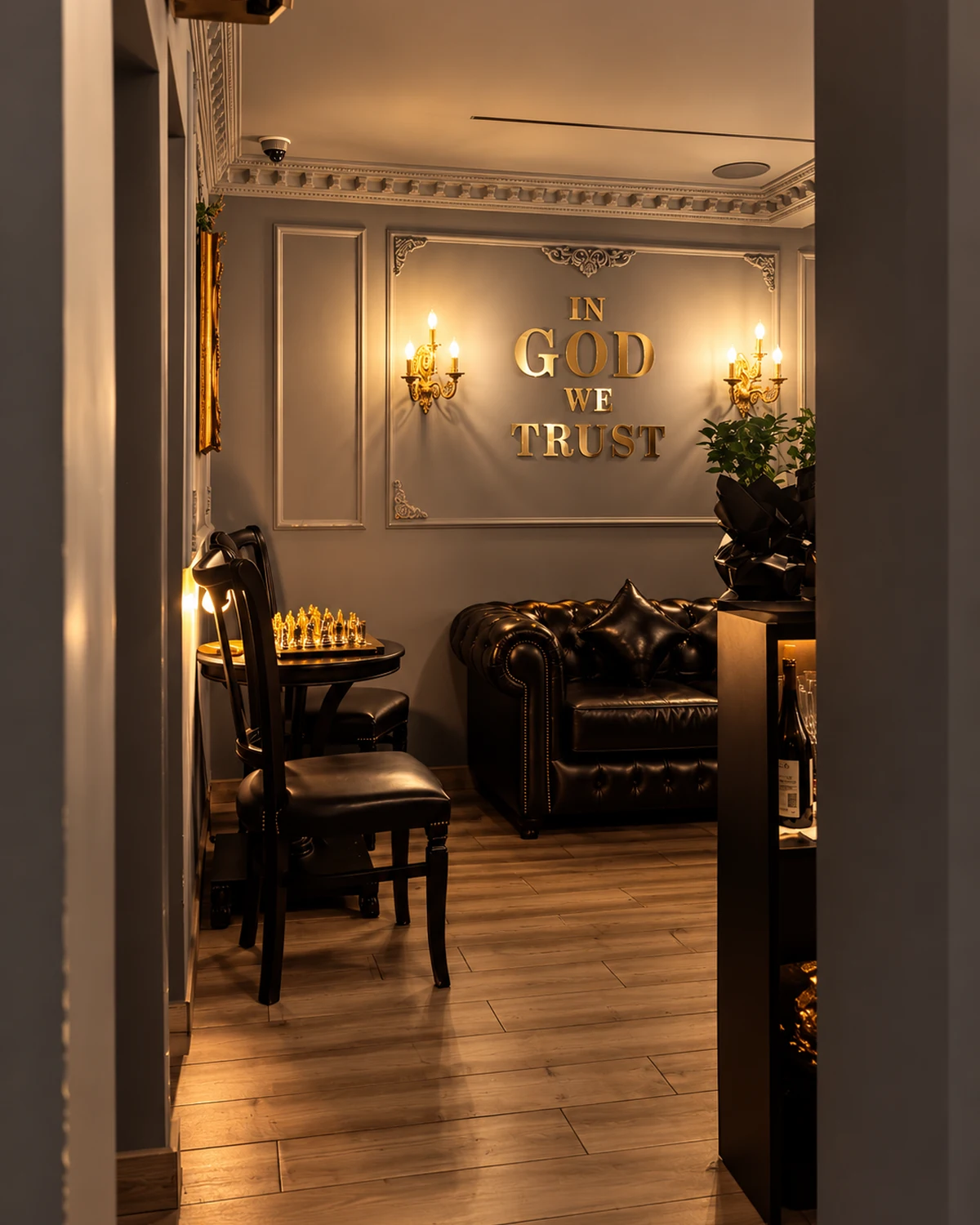 Lounge corner with a leather sofa, chess table and gold wall lettering